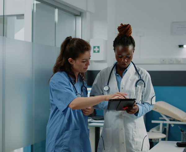 Doctor and nurse working with tablet for healthcare system